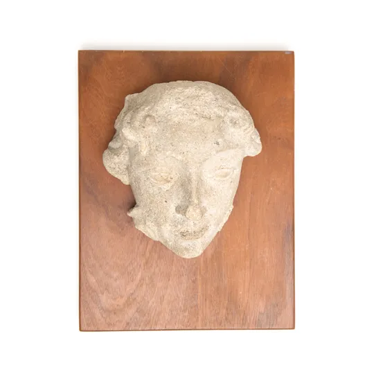 Carved stone head, 1200s.